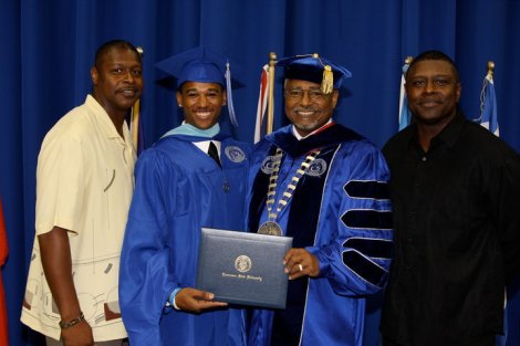 Franz receiving his  master's degree in 2010 with (l to r) his dad Roger Holmes '88, Dr. Melvin Johnson and uncle Eric Holmes '91.